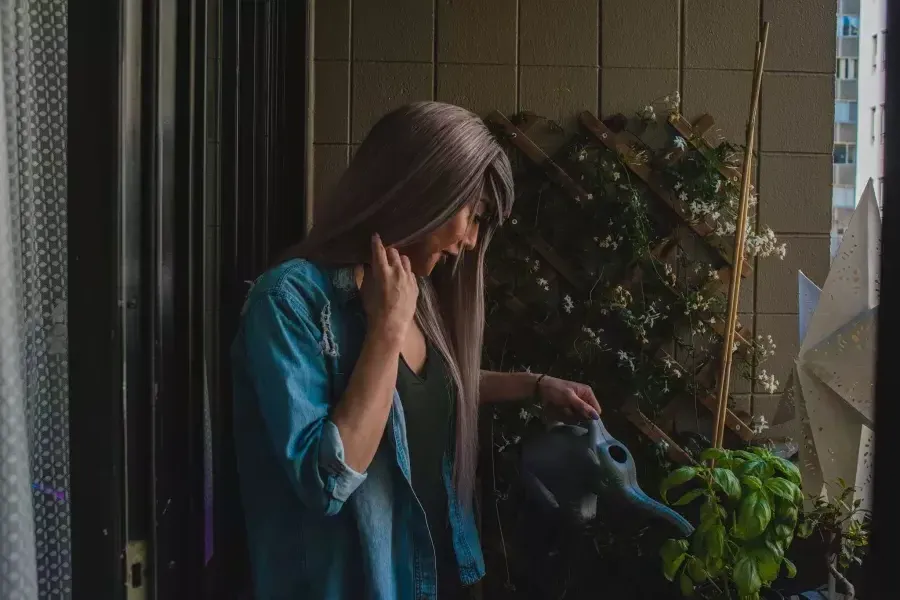 Nya Cruz watering plants.